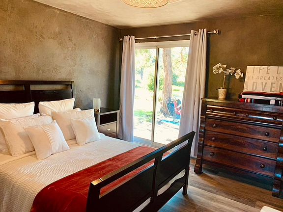 Wake up to a view and have coffee in bed while watching the river flow by! Master bedroom #1, has a queen bed, and an ensuite bathroom. Sliding glass doors give direct access to a patio, with chairs, the river, & hot tub is just outside the door!