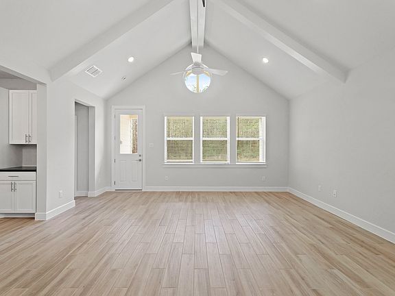 Great room with vaulted ceiling ceiling beams
