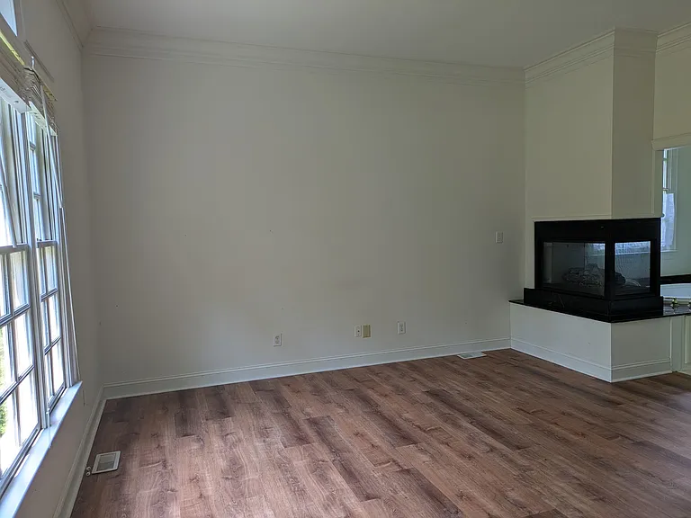 Another view of the primary bedroom with fireplace.