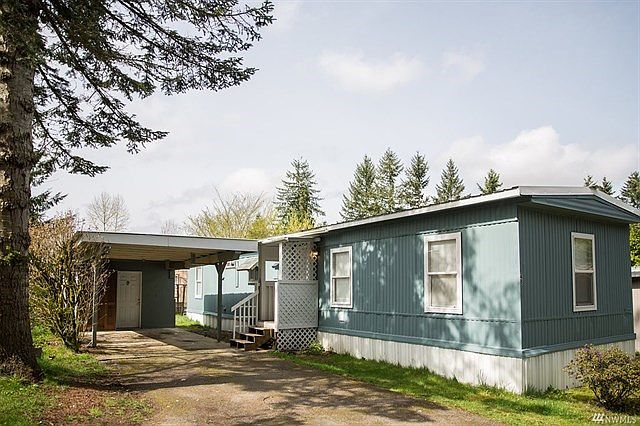 Updated Single Wide....Attached Carport with Storage Unit.