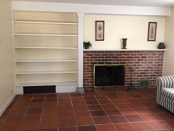 Lower Unit: Living area w/Fireplace & Built-In bookshelf