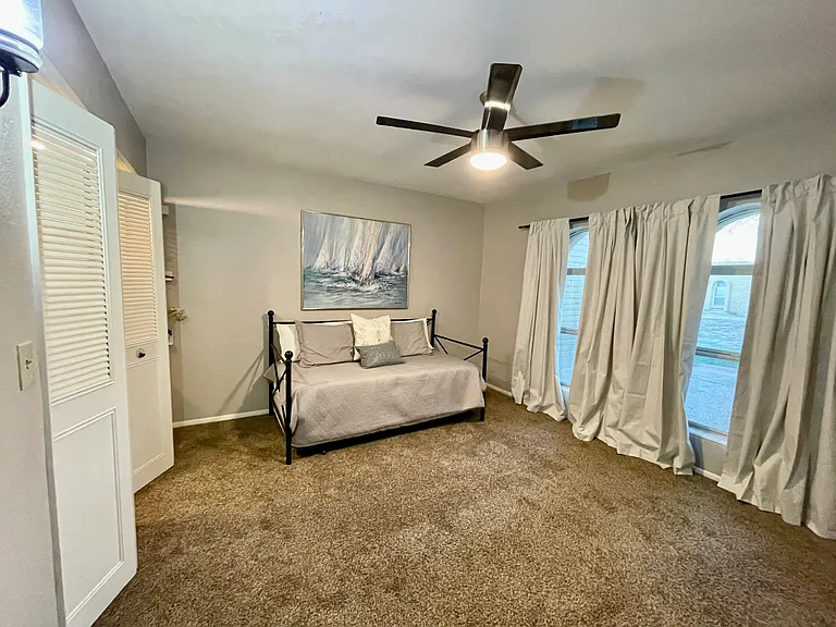 2nd bedroom with large windows and double door closet