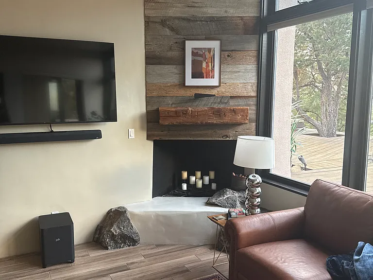 Living room with 65" LG Smart TV and Polk soundbar/sub woofer, served by 400 Mbps internet connection