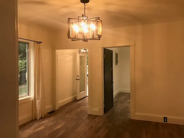 front room view into bedroom and entry