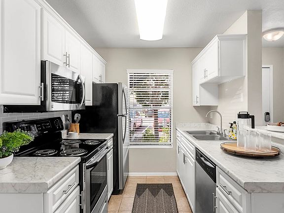 Our beautifully remodeled, chef-inspired kitchens adorned with opulent marble-like countertops and stainless-steel appliances.