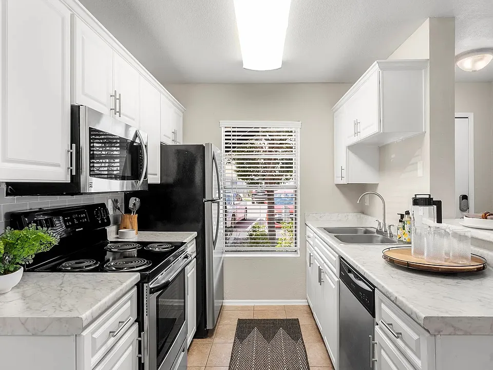 Our beautifully remodeled, chef-inspired kitchens adorned with opulent marble-like countertops and stainless-steel appliances.