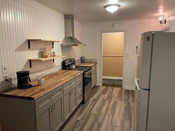 New stainless/black stove and vent hood.