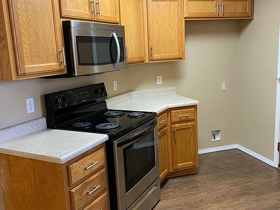 Left side of Kitchen with new stove and new microwave. All drawers and cupboards and large handle pulls.