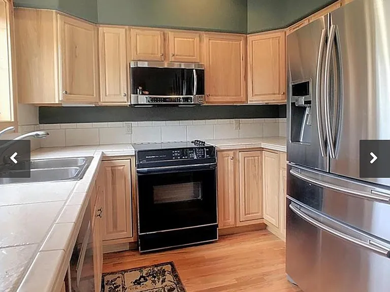 Fully equipped Kitchen w/ Knotty Alder Cabinetry, Hardwood Floors, Stainless Appliances.