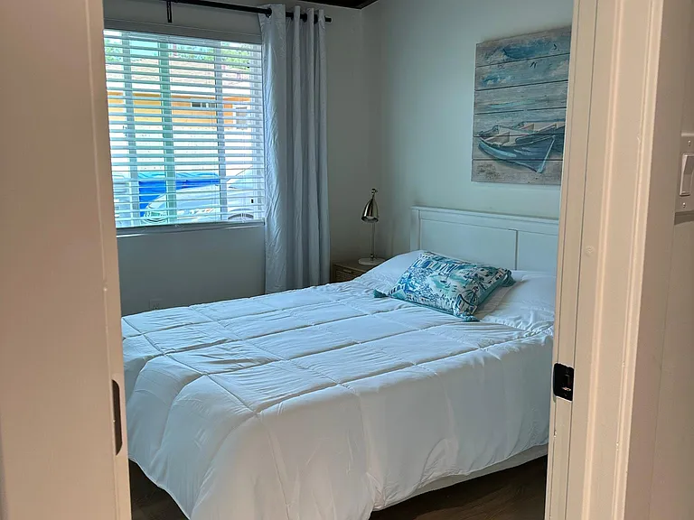 Comfortable queen bed, wood beamed ceilings, paddle ceiling fan mirrored closet doors, fun beachy theme.