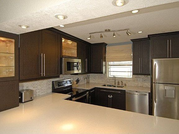 Upgraded Quartz Counters & Laminate Wood Cabinets.