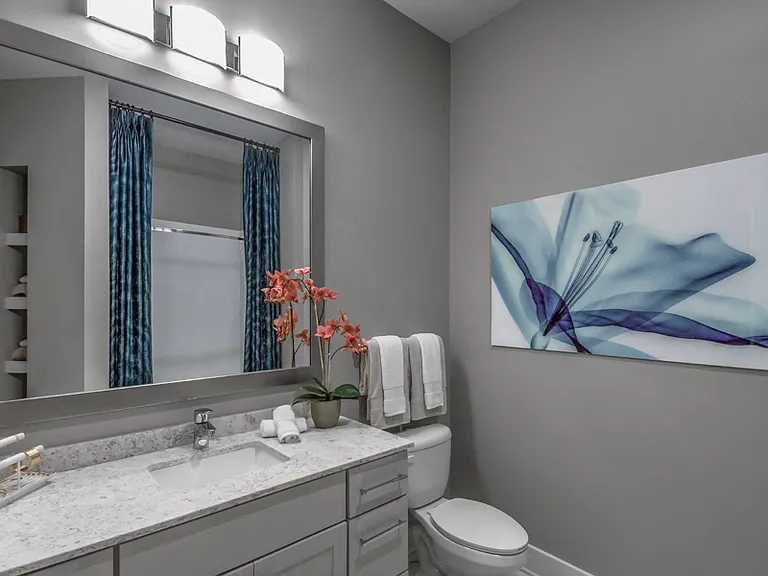 Bathrooms with framed mirrors and contemporary lighting