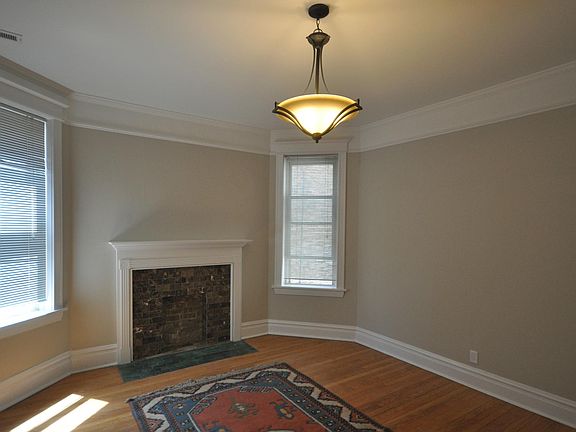 Bedroom with decorative fireplace