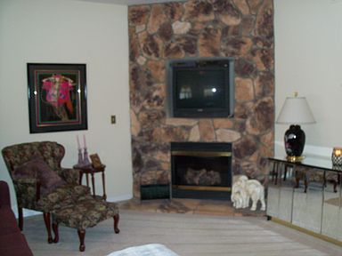 Vaulted Great Room with Corner Stone gas fireplace, wall to wall carp