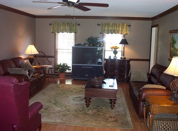 Large family room with beautiful crown molding and chair rail. New fan.