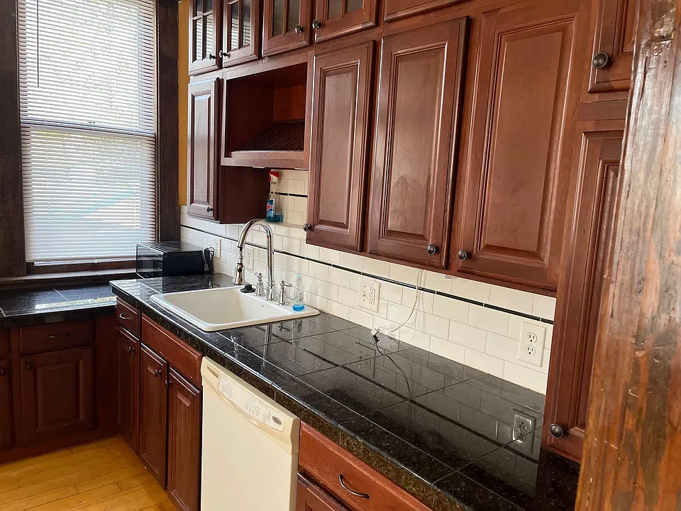 Kitchen with dishwasher and granite counters