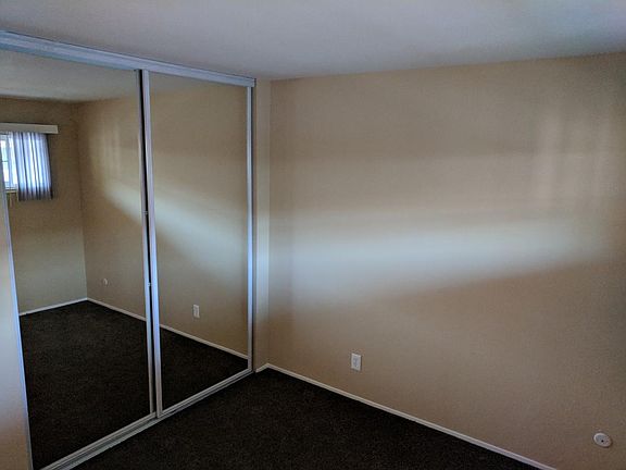 Second bedroom with reflective sliding glass doors