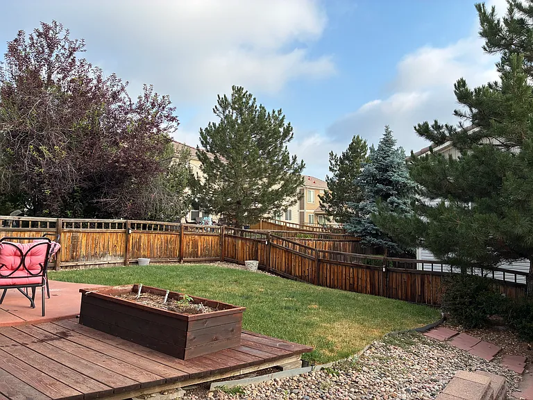 Backyard is fenced with a raised bed on a drip system