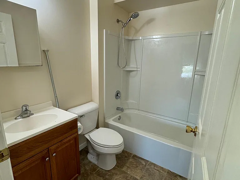 Bathroom with new massaging shower head and closet