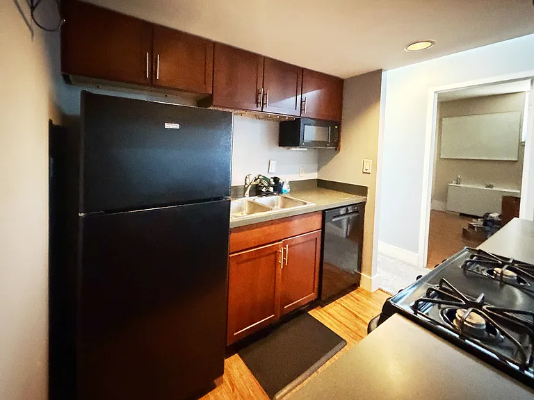 Kitchen
Fully equipped kitchen featuring gas range, dishwasher, refrigerator, and rich wood cabinetry