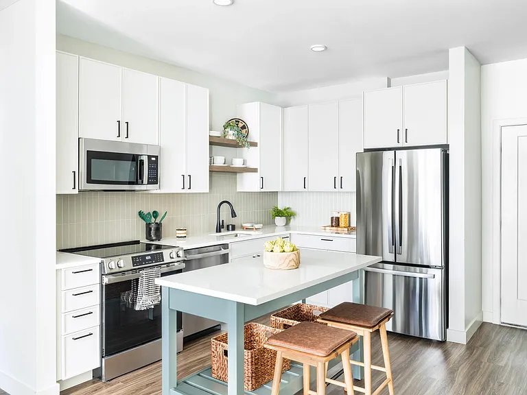 Crisp white cabinetry, stainless steel appliances, and coastal-inspired details bring warmth and ease to Modera South Shore kitchens.