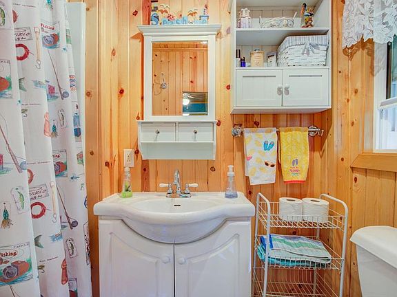 Bathroom has a shower, sink and toilet.