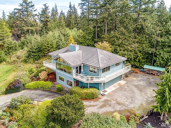 The property is a shy 1/2 acre, with terraced gardens on the west side of the lot and a wooded buffer on the east side.