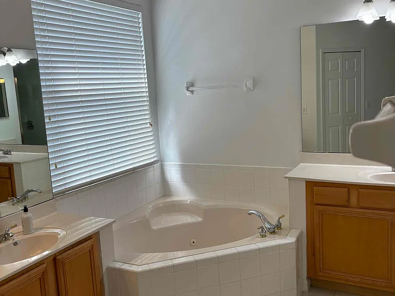 Master bath with Roman tub and his and hers vanities