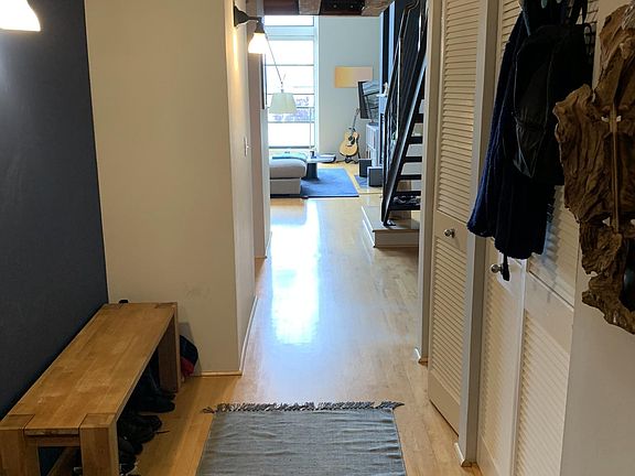 Entry from the front door, passing by the 1/2 bathroom, laundry closet, utility closet, and desk area