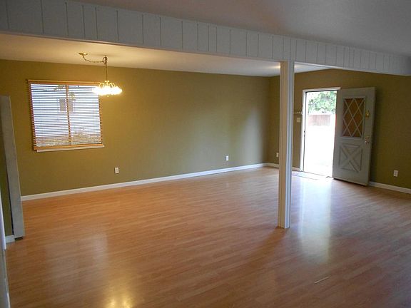 downstairs dining/living room combo showing front door entra