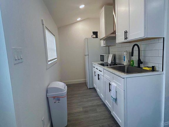 Cozy kitchen equipped with fridge and essential amenities.