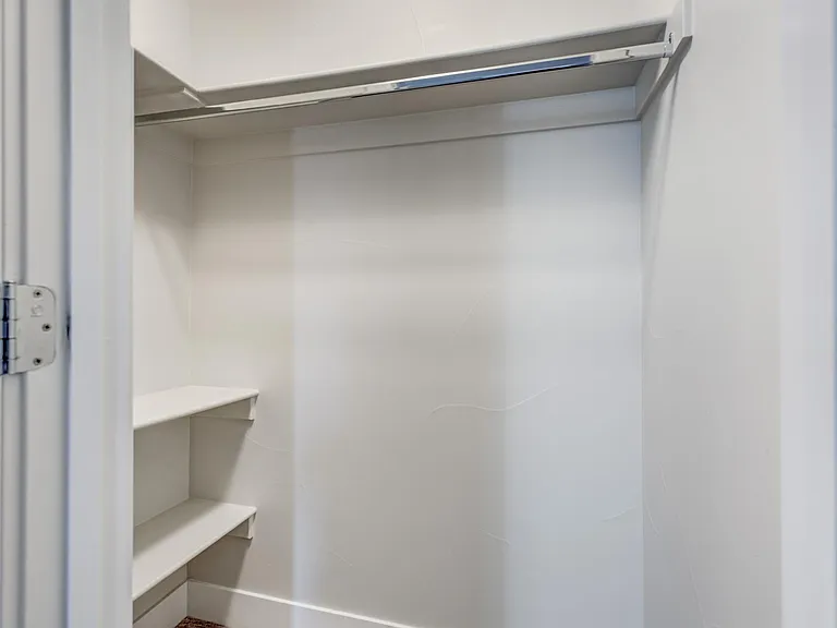 Primary bedroom walk-in closet