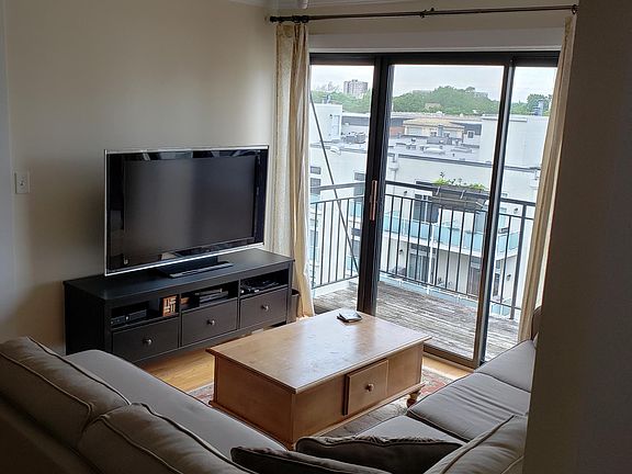 Living room showing large TV and console table.
