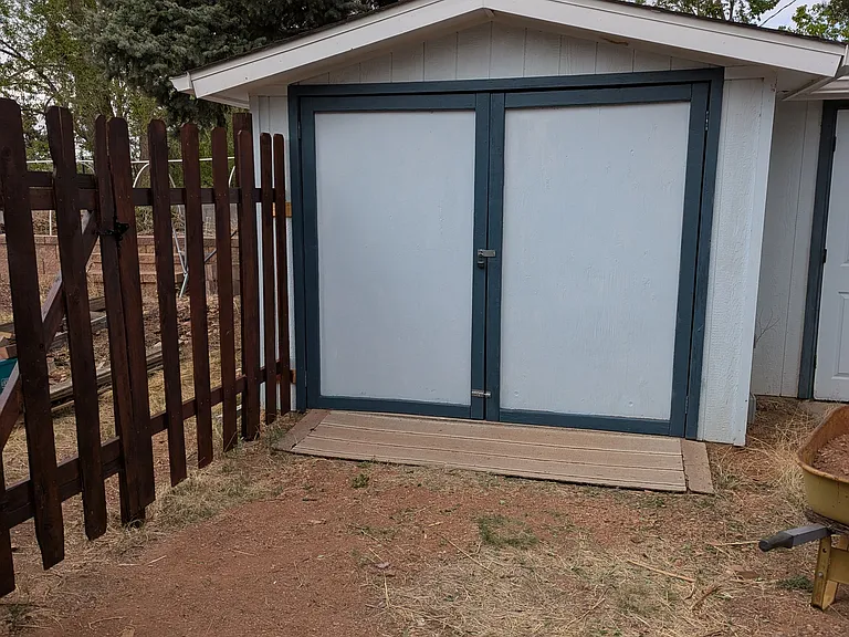 Shed is owner occupied (stuff, not people) but has the potential to become available in 6 months. Dog area on this side of residence.