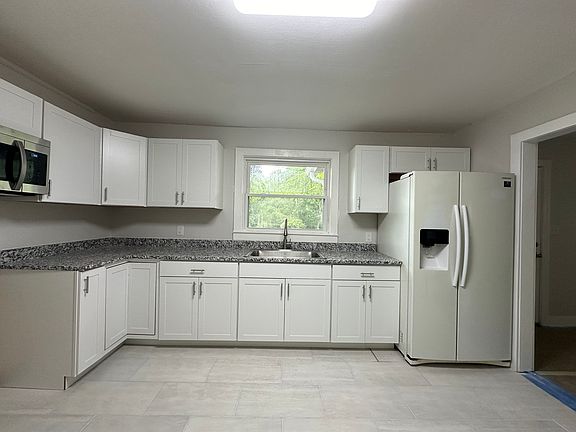 Brand new kitchen cabinets and granite countertops. Stainless steel range will be installed under microwave.