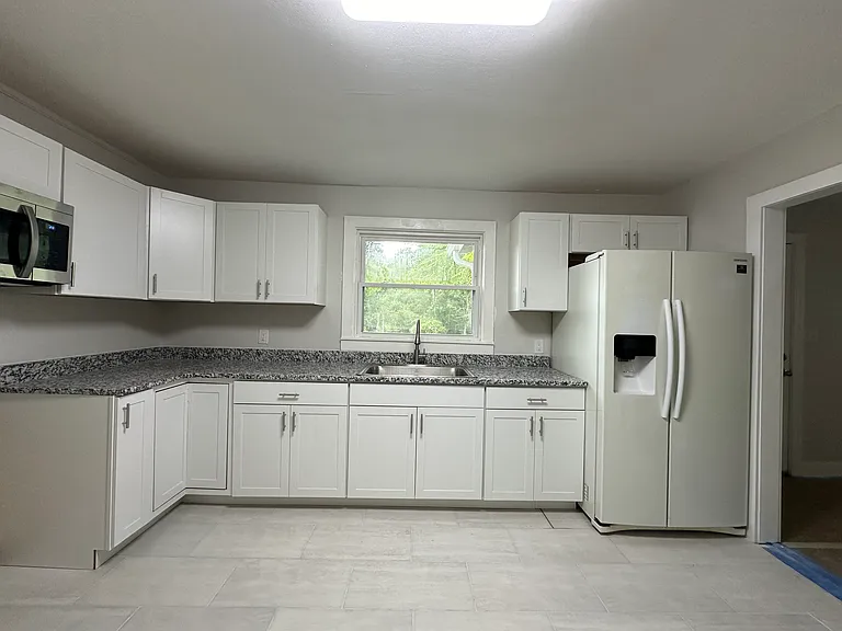 Brand new kitchen cabinets and granite countertops. Stainless steel range will be installed under microwave.