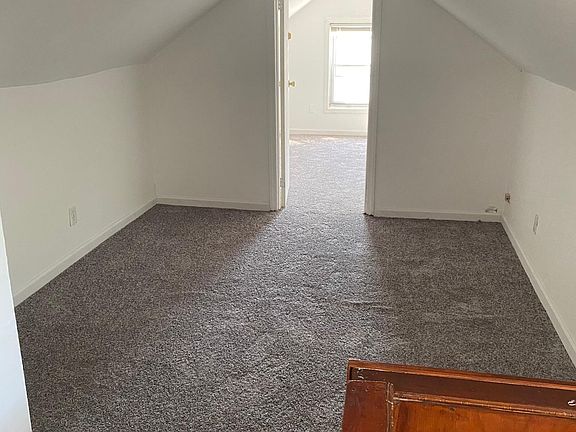 Open space used as a sitting area between two rooms in attic.