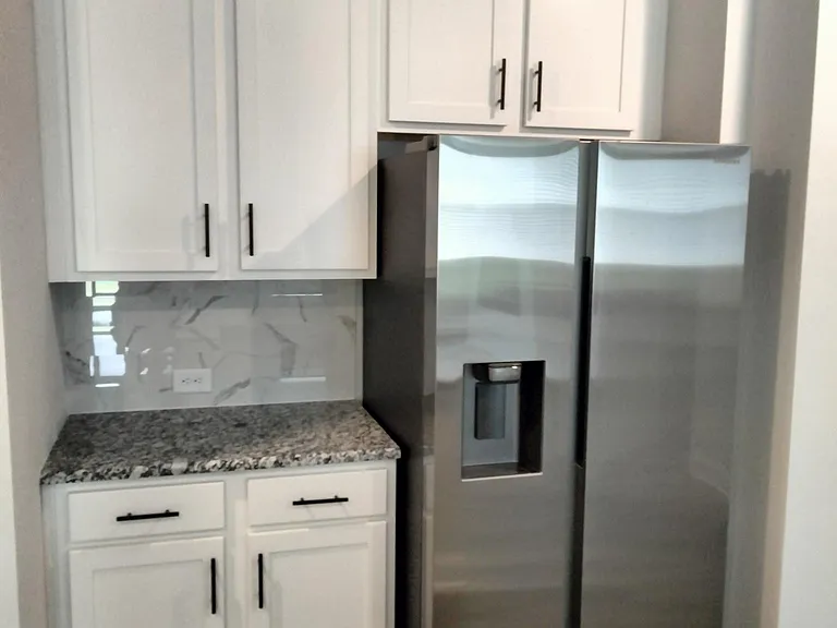Stainless Steel Samsung Refrigerator and Additional Cabinets