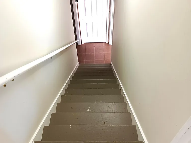 Stairway to large partially finished basement