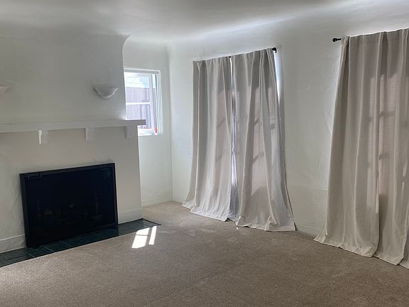 Coved ceilings together with the plaster fireplace add to the charm of this renovated Spanish revival home.
