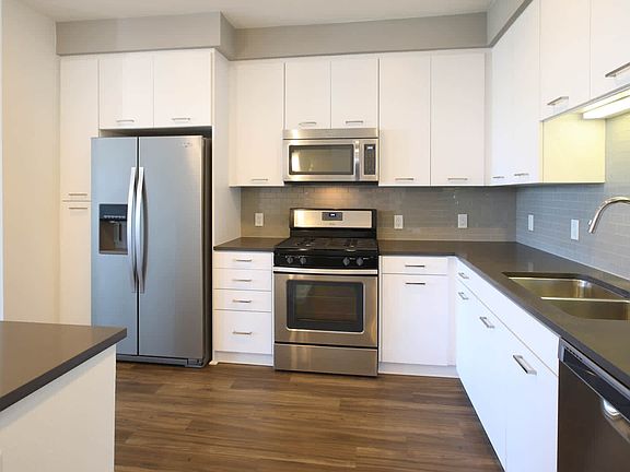 Kitchen with Stainless Steel Appliances and In-home Washer and Dryer