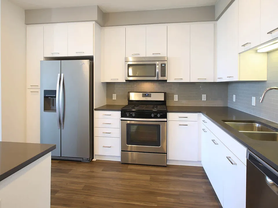 Kitchen with Stainless Steel Appliances and In-home Washer and Dryer