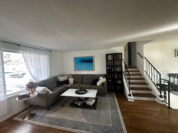 Main floor living room offers generous space and abundant natural light from large windows.