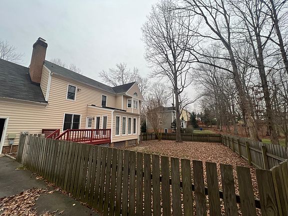 Fenced in backyard with deck.