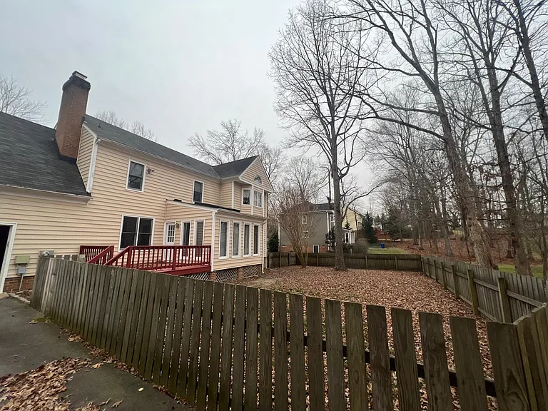 Fenced in backyard with deck.
