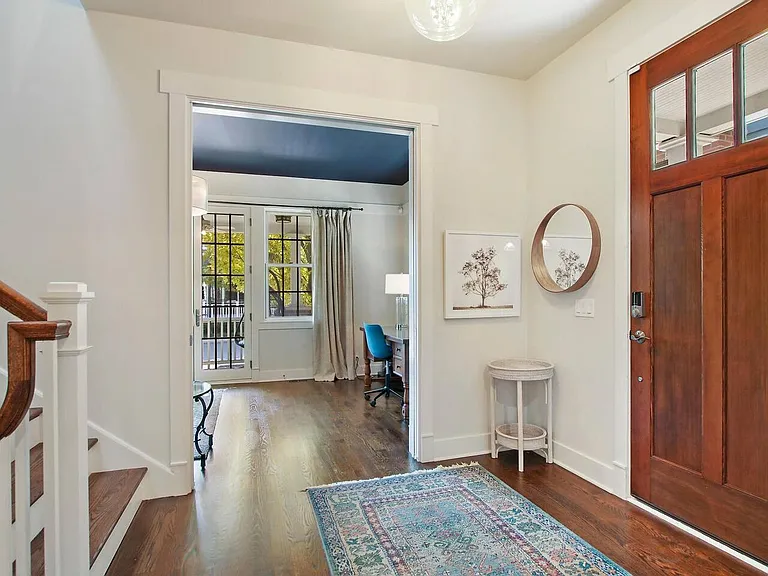 Generous front foyer with view to front sitting room/office and french doors leading to covered porch.