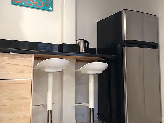 Kitchen stools and counter with refrigerator