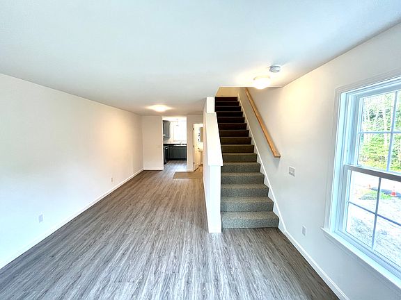 living room with stairs to bedrooms