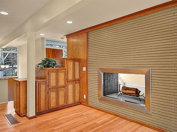 Breakfast nook next to see-through fireplace.