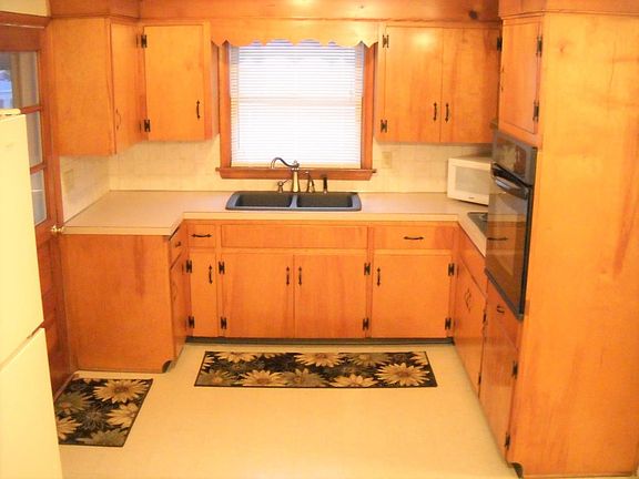 all wood cabinets with lots of storage and screened in porch